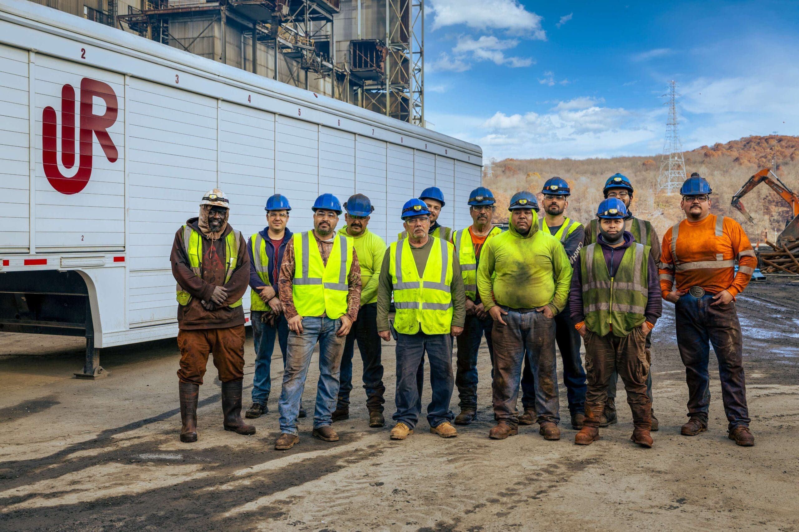 UIR crew in high-visibility workwear beside a company trailer