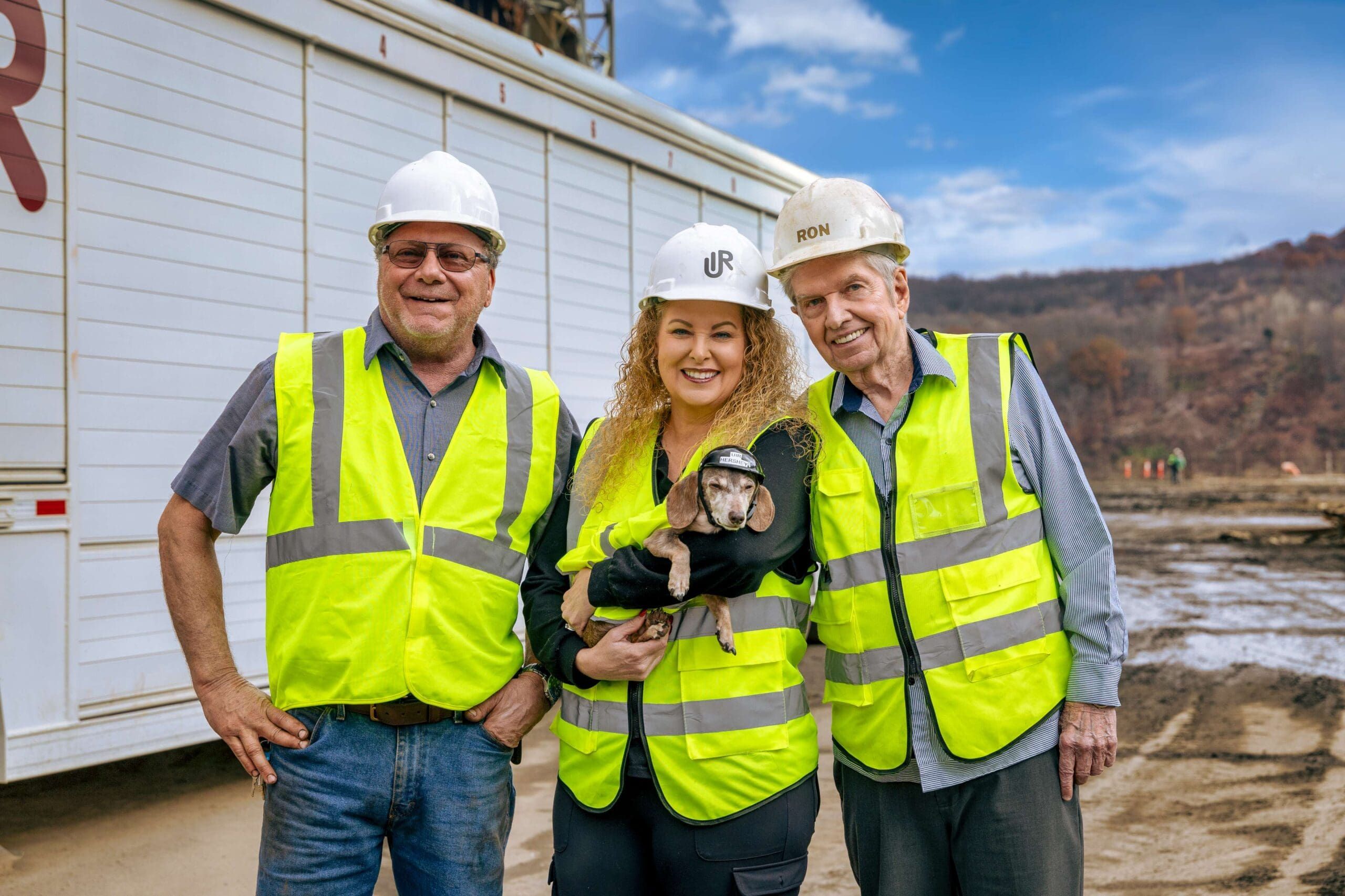 Dewayne Carter, Kristie Carter, and Ronald Ritter beside a UIR trailer